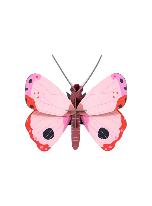 A soft pink butterfly that drifts across your wall, combining poetic elegance, graphic beauty, and eco-conscious design by Studio ROOF.